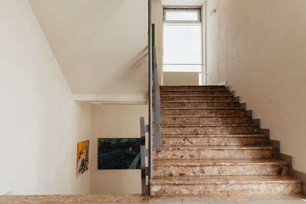 brown wooden staircase near white wall