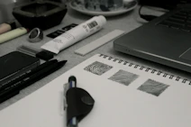 A creative workspace with branding sketches and black-and-white design elements on a desk.