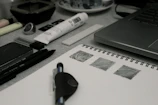 A panoramic view of a creative workspace filled with sketches, digital screens, and art supplies.