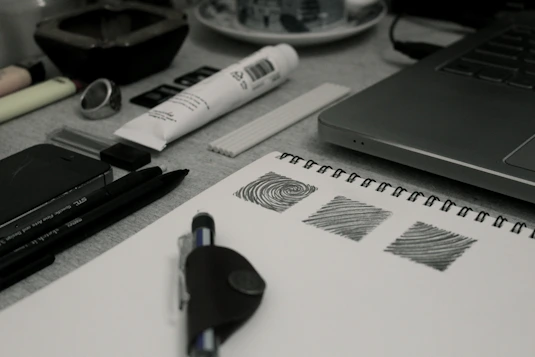 A creative workspace with blue and white design elements, showcasing sketches and digital design tools.