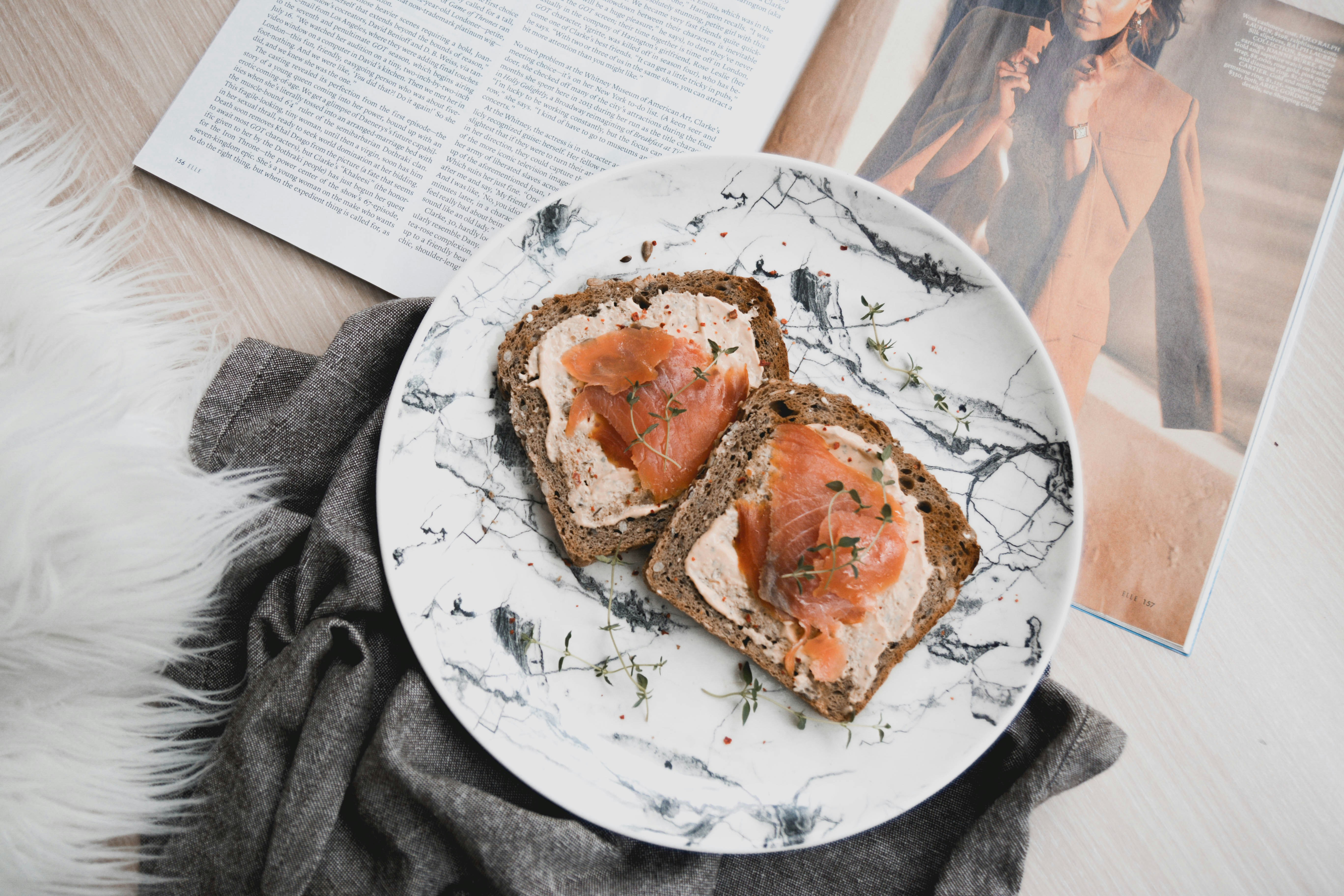 brown bread on white and blue floral ceramic plate, Salmon slices on toast for breakfast