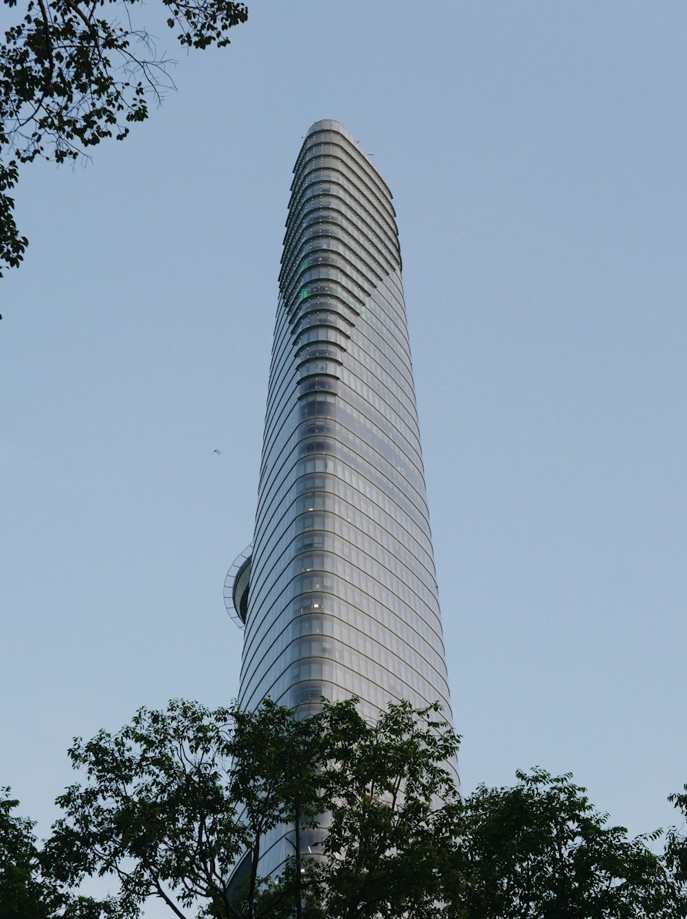 white concrete building near green trees during daytime