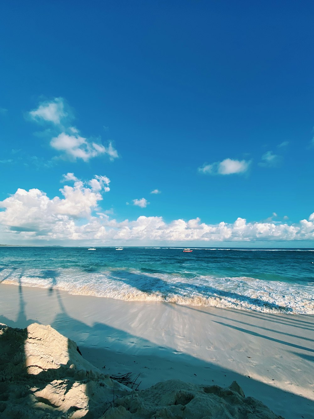 blue sea under blue sky and white clouds during daytime