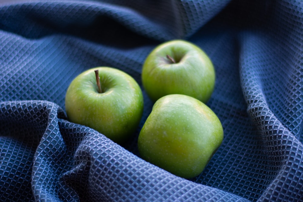 green apple on black and white checkered textile