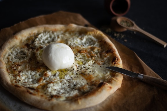Close-up of creamy mozzarella cheese with fresh herbs and spices.
