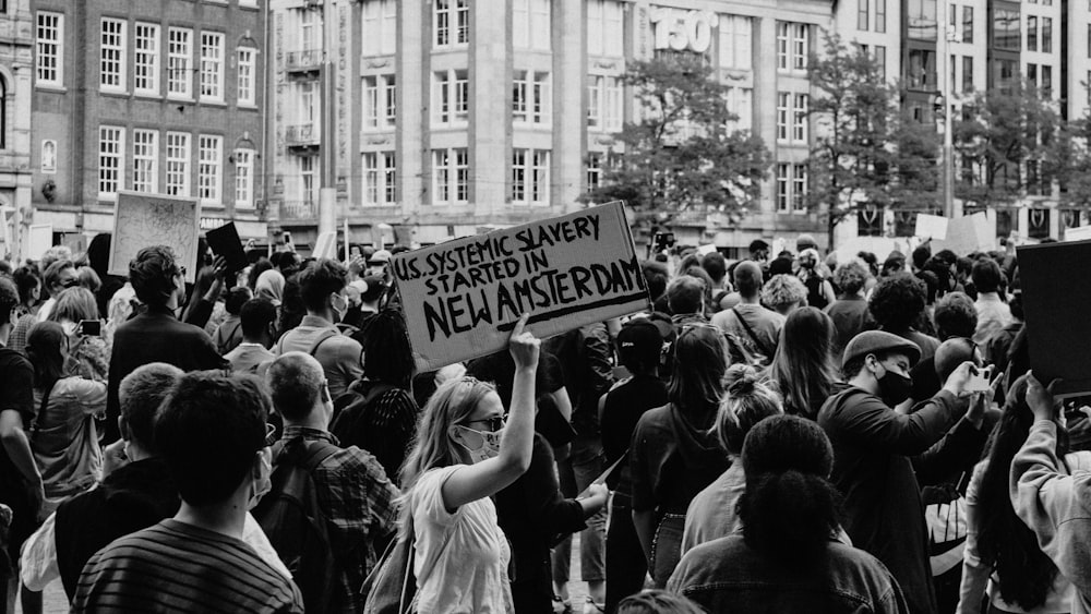 grayscale photo of people holding signage