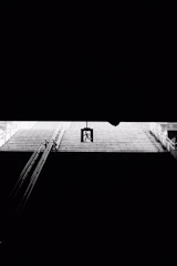 Emergency lights illuminating a stairwell in a residential building.