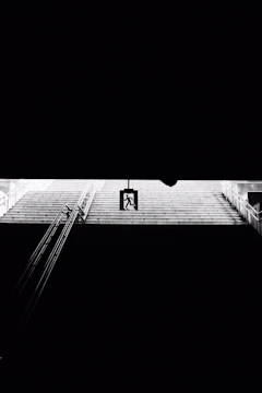 Emergency lights illuminating a stairwell in a residential building.