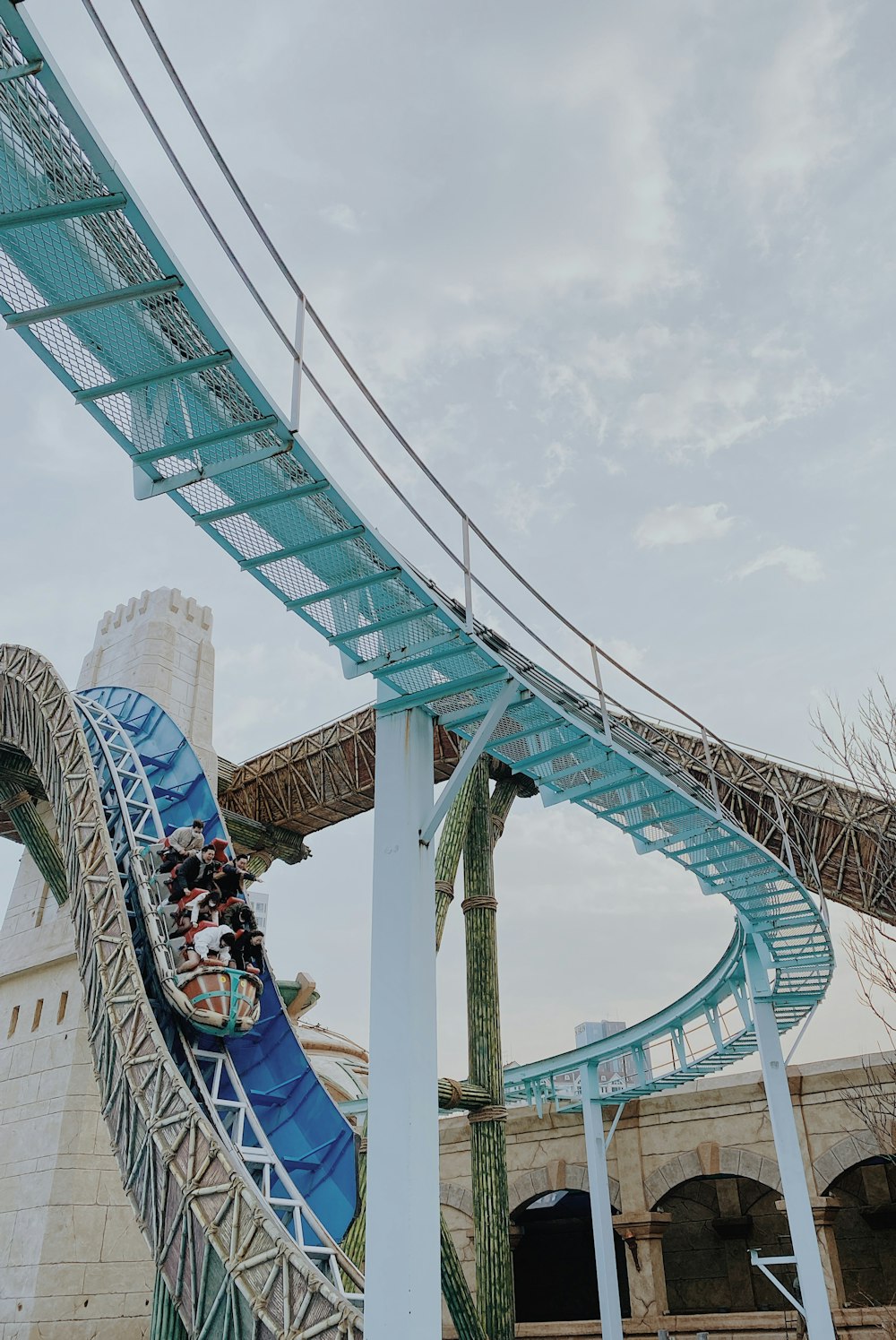 people walking on teal and white bridge during daytime