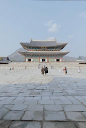 a couple of people standing in front of a building