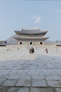 a couple of people standing in front of a building