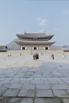 a couple of people standing in front of a building