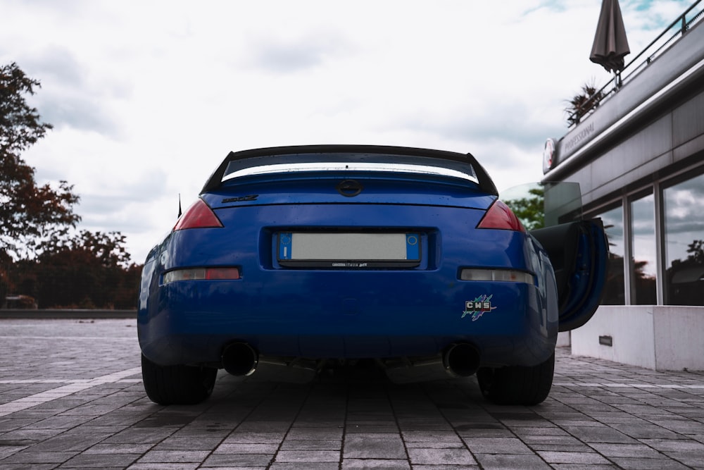 blue chevrolet camaro on gray pavement