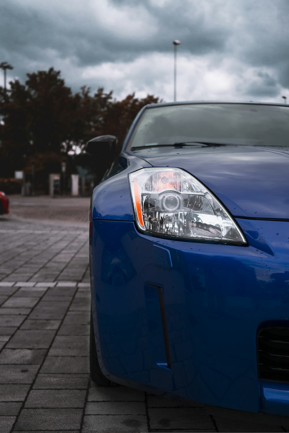 blue car on gray concrete road during daytime