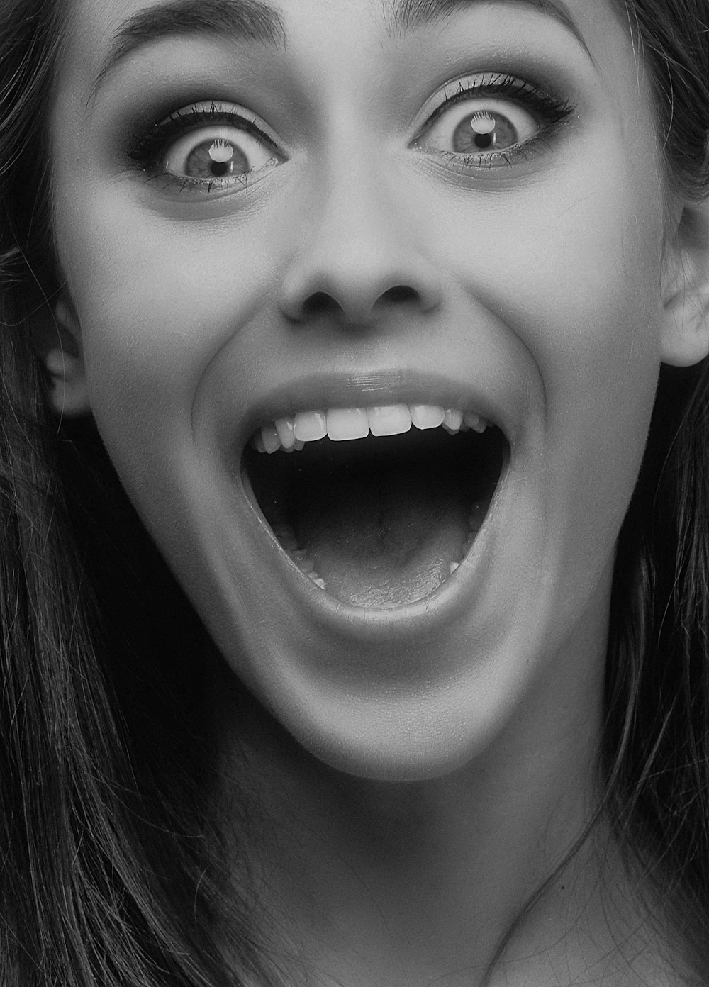 grayscale photo of woman open mouth