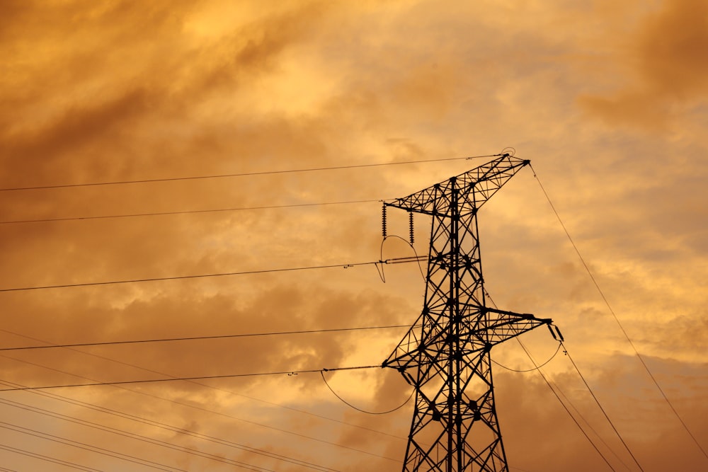 black electric post under cloudy sky