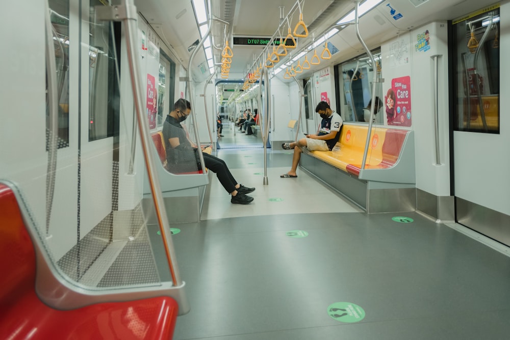 woman in black pants sitting on train