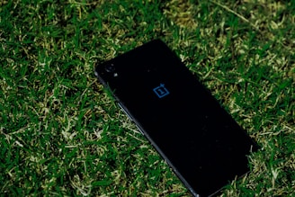black iphone 5 on green grass