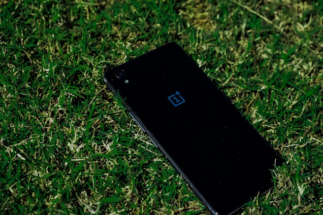 black iphone 5 on green grass