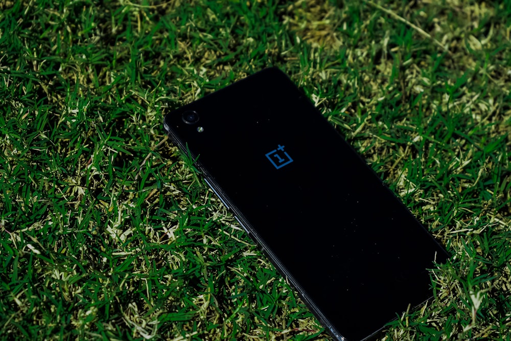 black iphone 5 on green grass