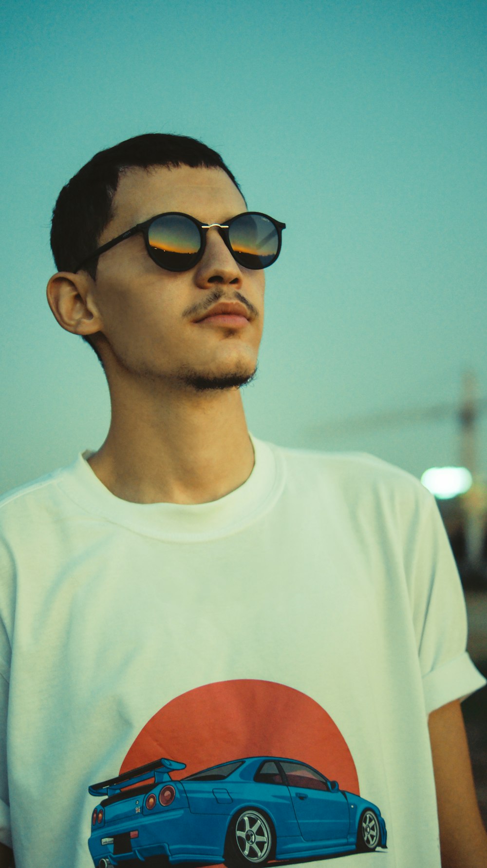 man in white crew neck shirt wearing black sunglasses