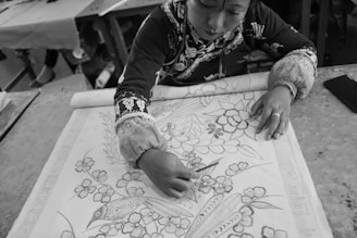 A designer working on a textile pattern in a creative studio.