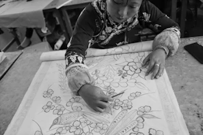 Brazilian artisan working on a hexagonal design with passion and focus