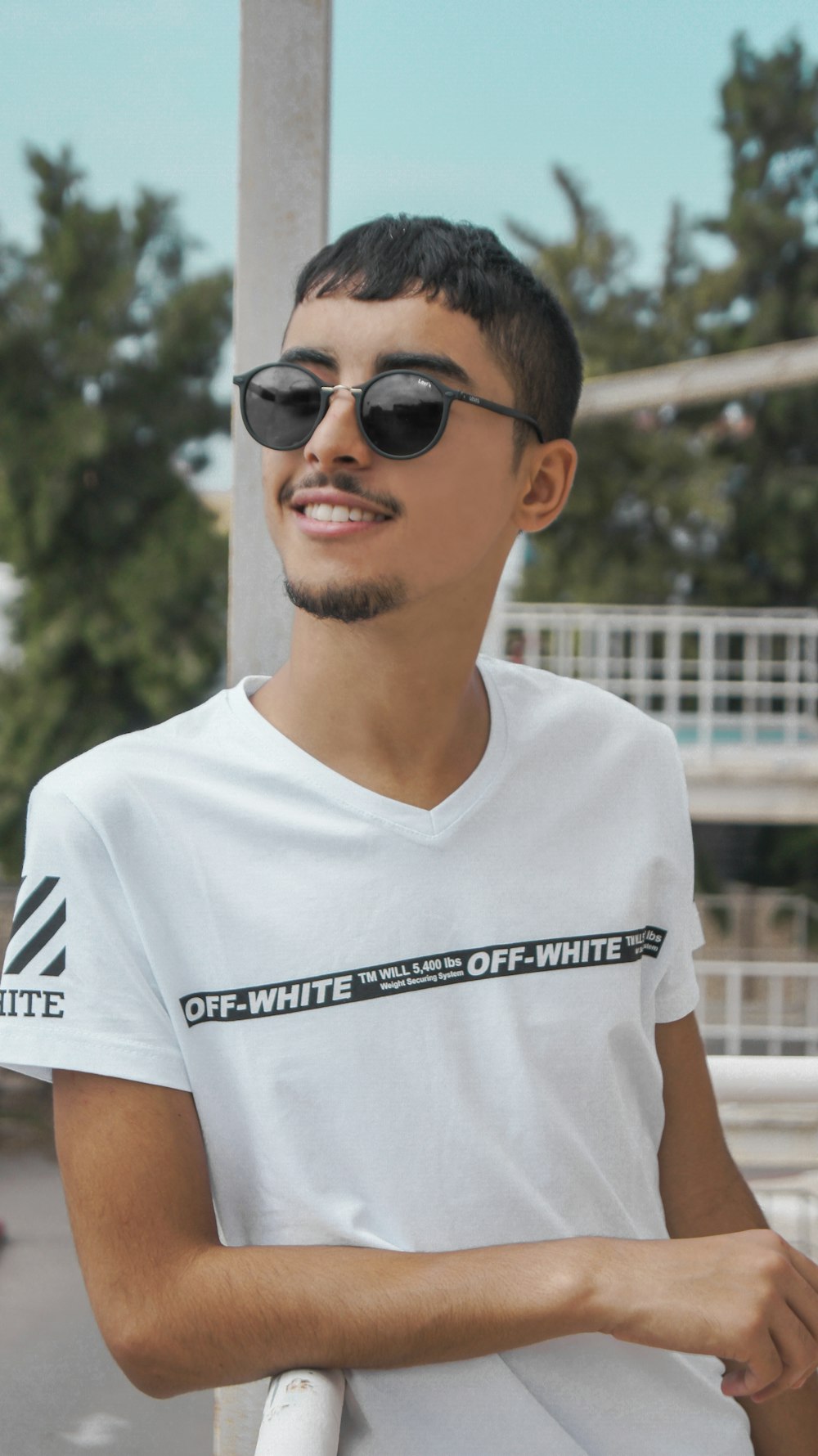 man in white crew neck t-shirt wearing black sunglasses
