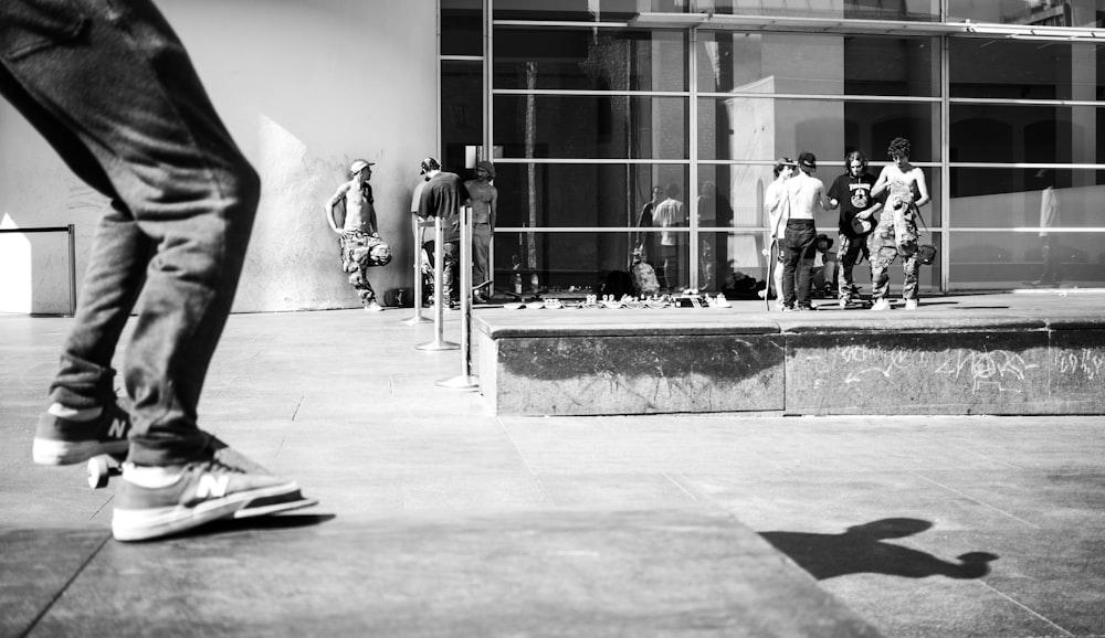 grayscale photo of people walking on sidewalk