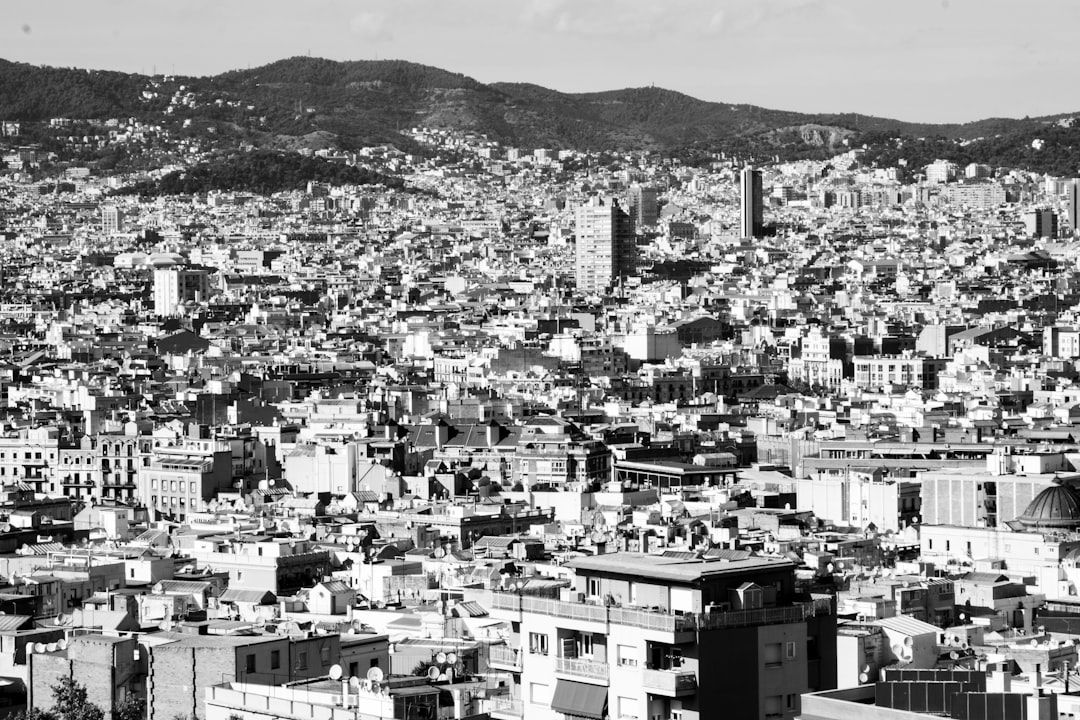 grayscale photo of city buildings near mountain