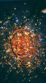 Close-up of spirals crafted from copper, catching the light.