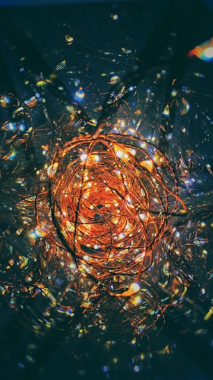 Close-up of copper vortex coil glowing softly with harmonic frequency waves.