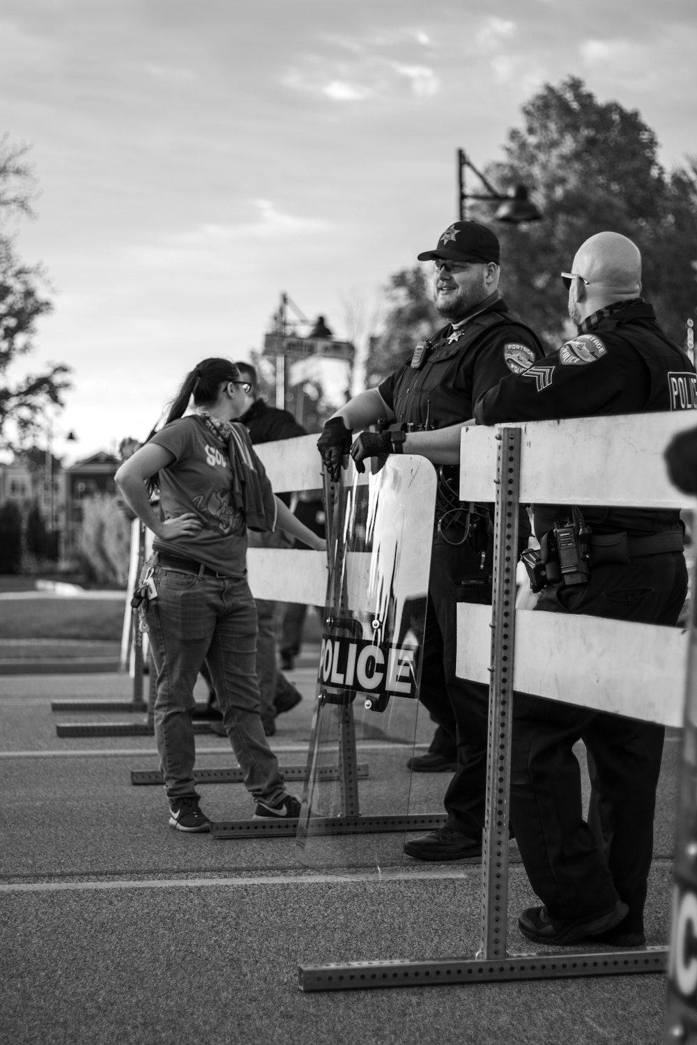 grayscale photo of man and woman walking on street