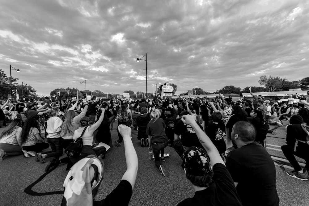 grayscale photo of people on field