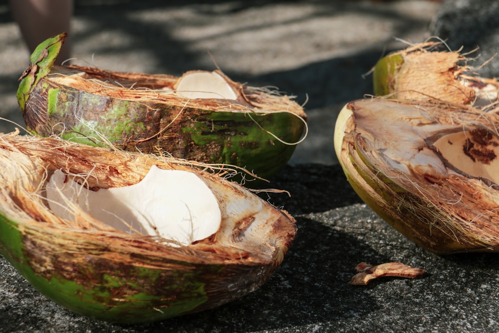 brown and green coconut shell on black soil