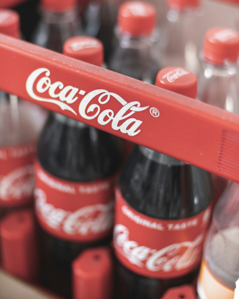 coca cola plastic bottle on red plastic crate