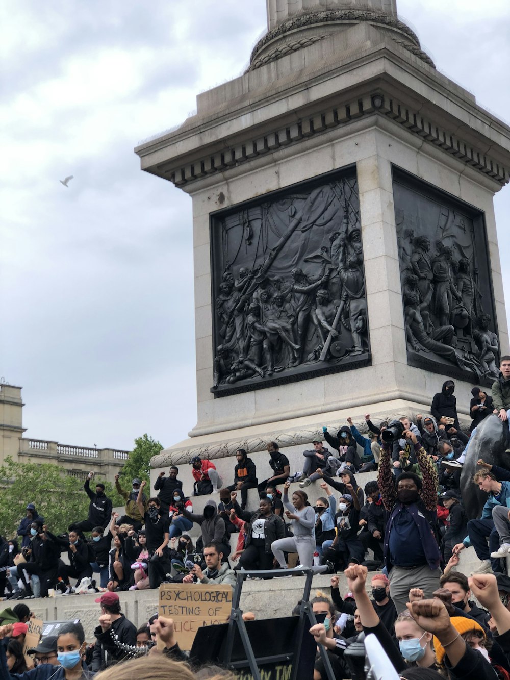 people gathering in front of gray concrete statue during daytime