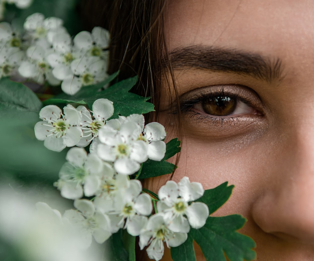 woman with white flowers on her ear