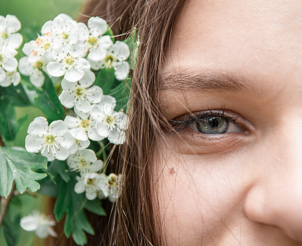 woman with white flower on her ear