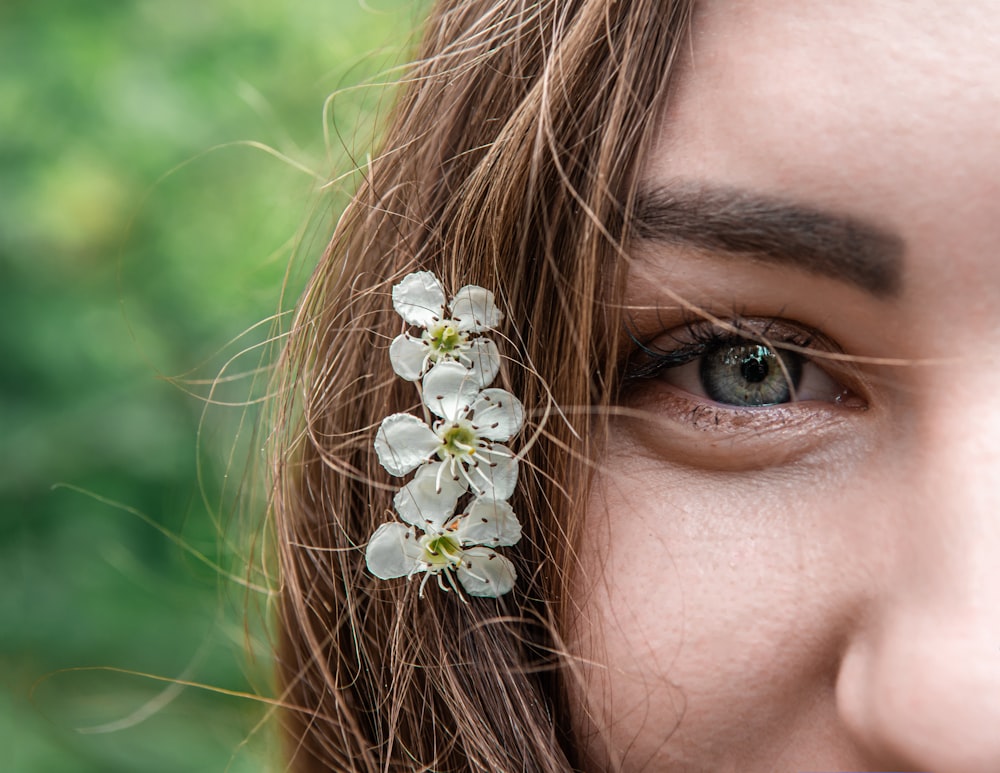 woman with white flower on her ear