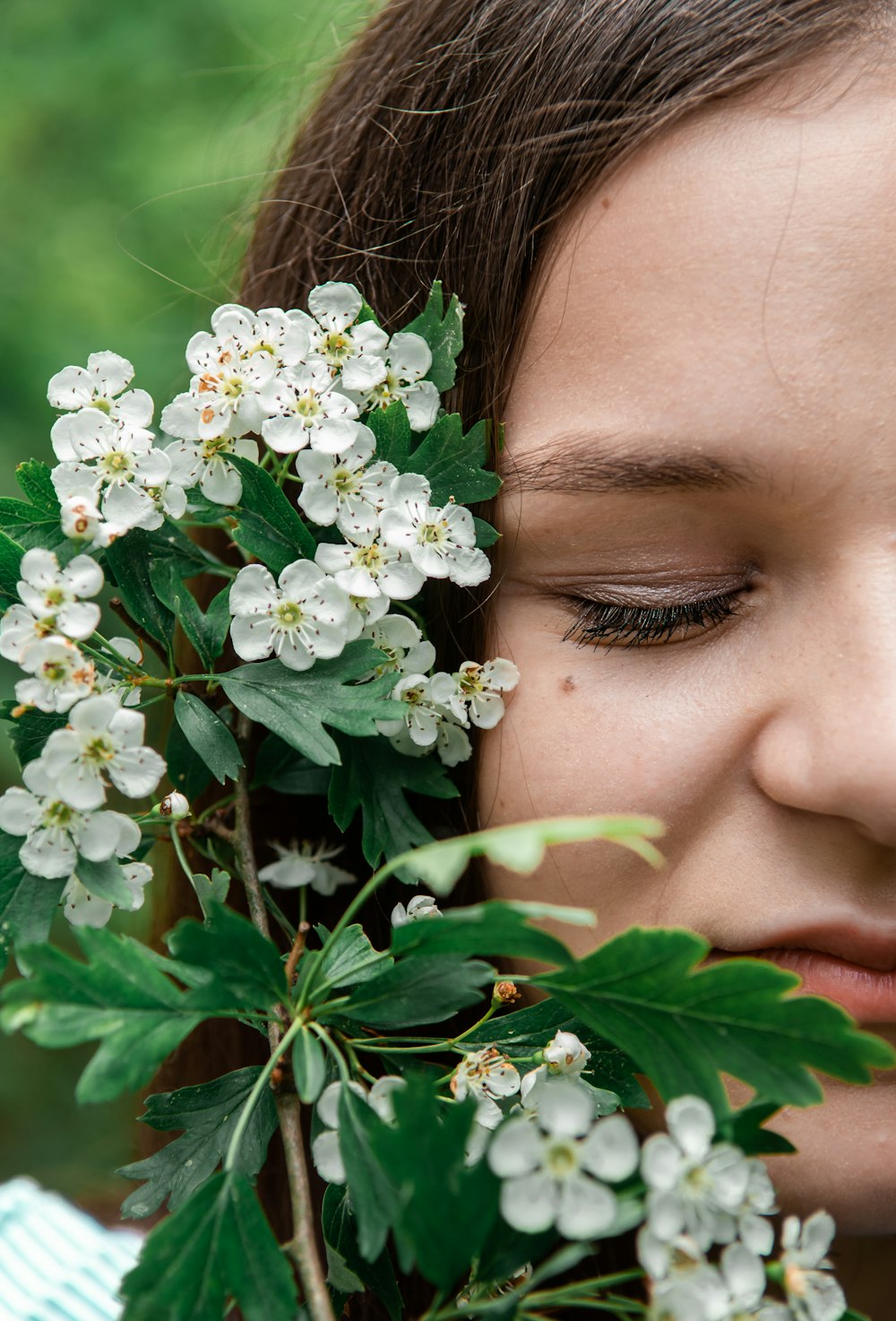 woman in green eye shadow in white flowers