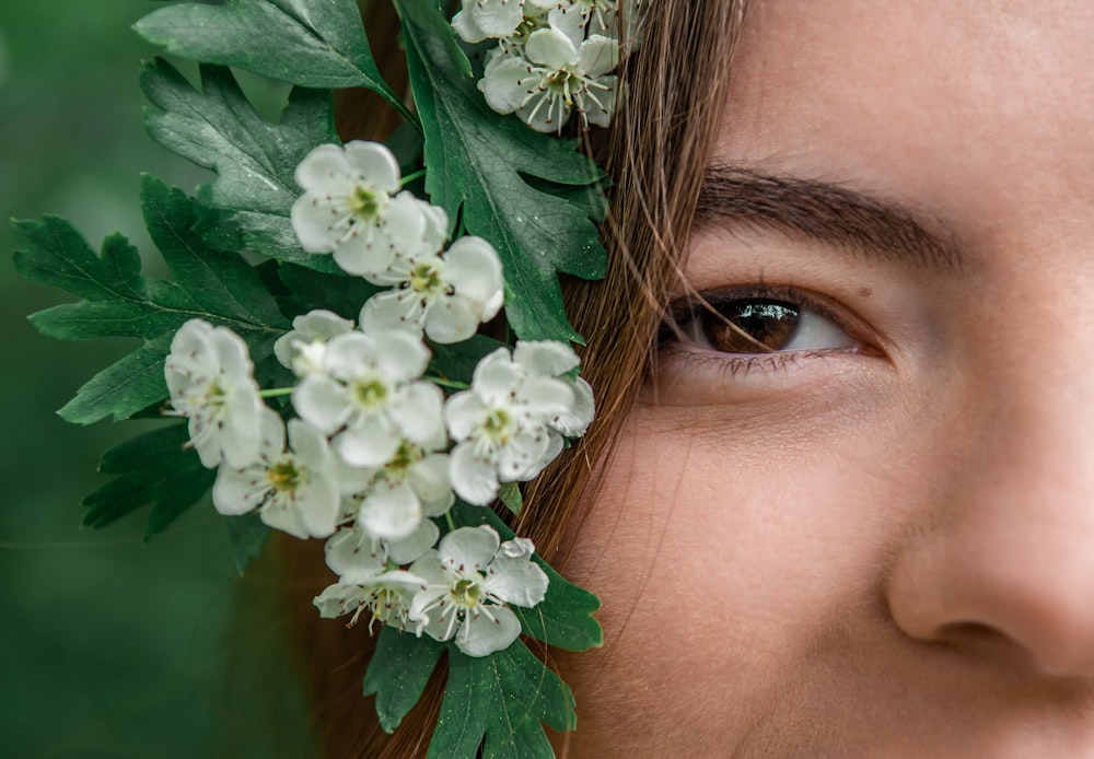 woman with white flower on her ear