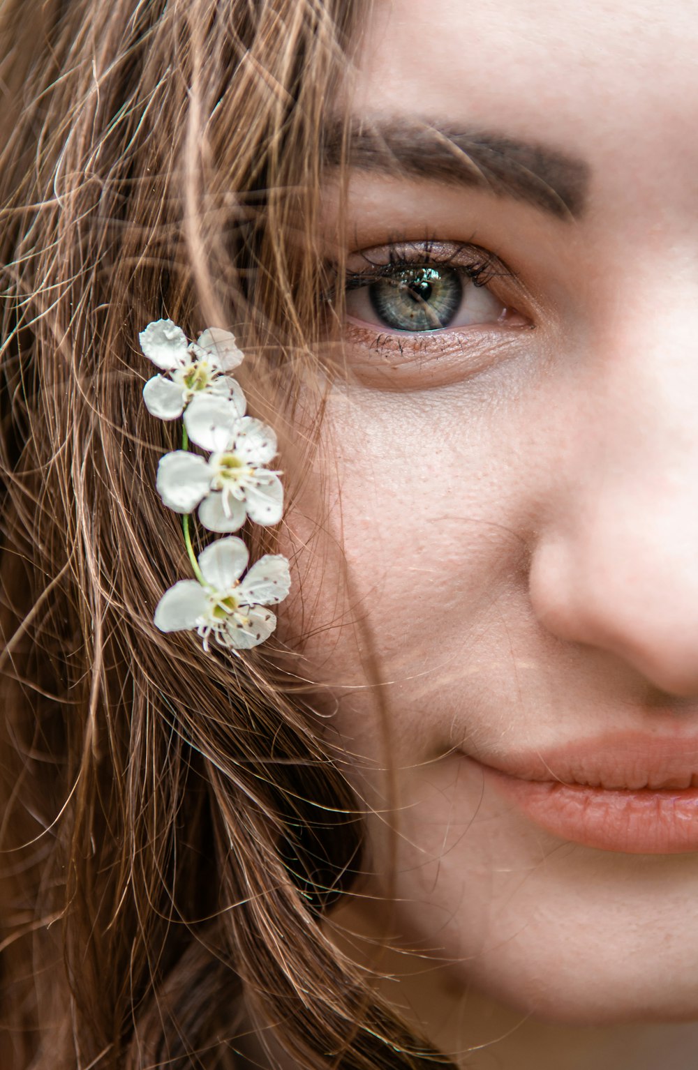 girl with white flower on her ear