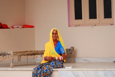 woman in yellow hijab sitting on white wooden table