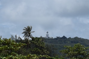 The majestic Big Buddha statue towering over the lush hills of Phuket surrounded by clouds