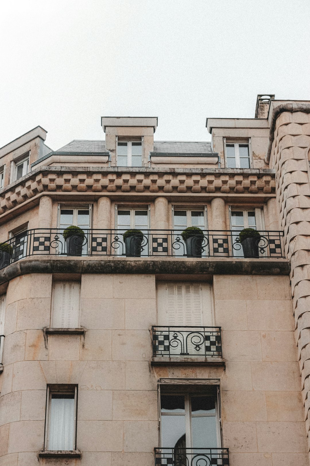 brown concrete building with black metal window