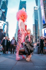 man in red wig and black and white striped long sleeve shirt standing on street during