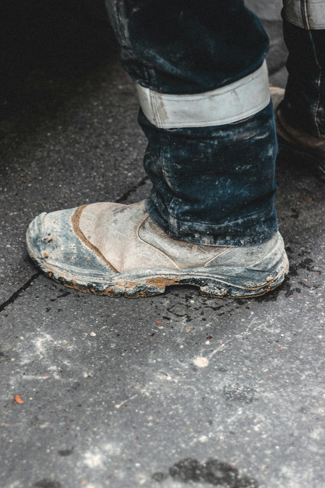 person wearing blue denim jeans and brown and black hiking shoe