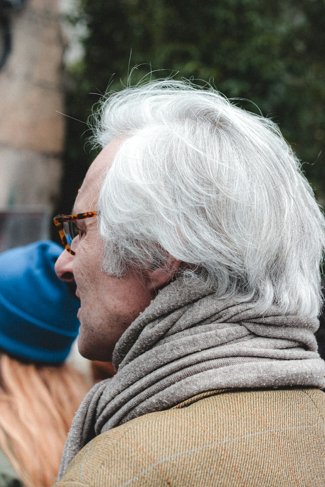 man in grey sweater wearing brown framed eyeglasses