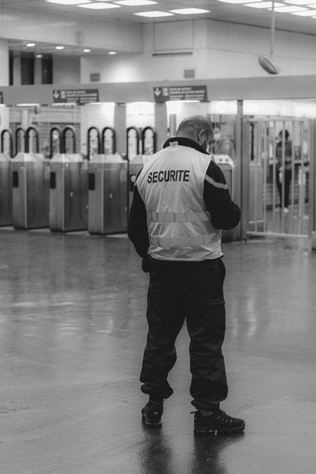 man in white and black hoodie and black pants standing on white floor